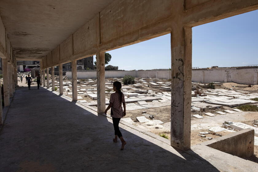 Palestinians make graves from the rubble of Gaza's destroyed homes