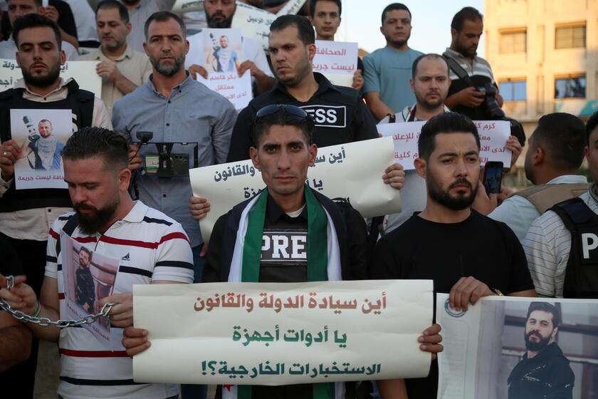 Syrian journalists protest after a colleague was arrested in northern Syria